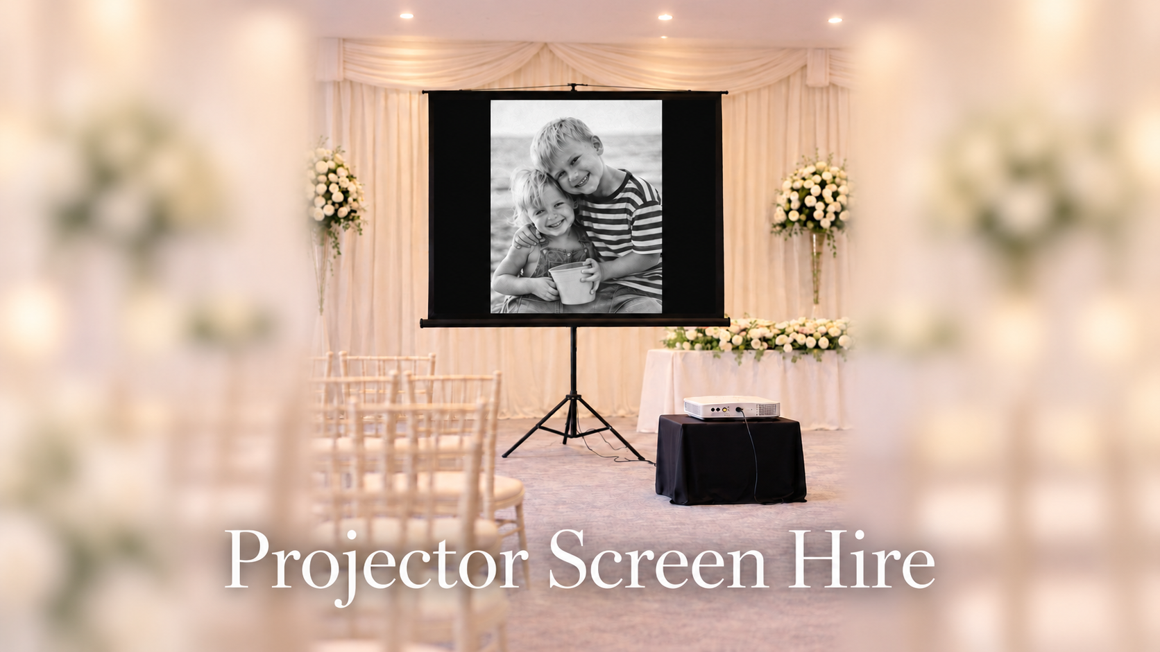 Projector and screen at an event venue, with the caption Projector Screen Hire.